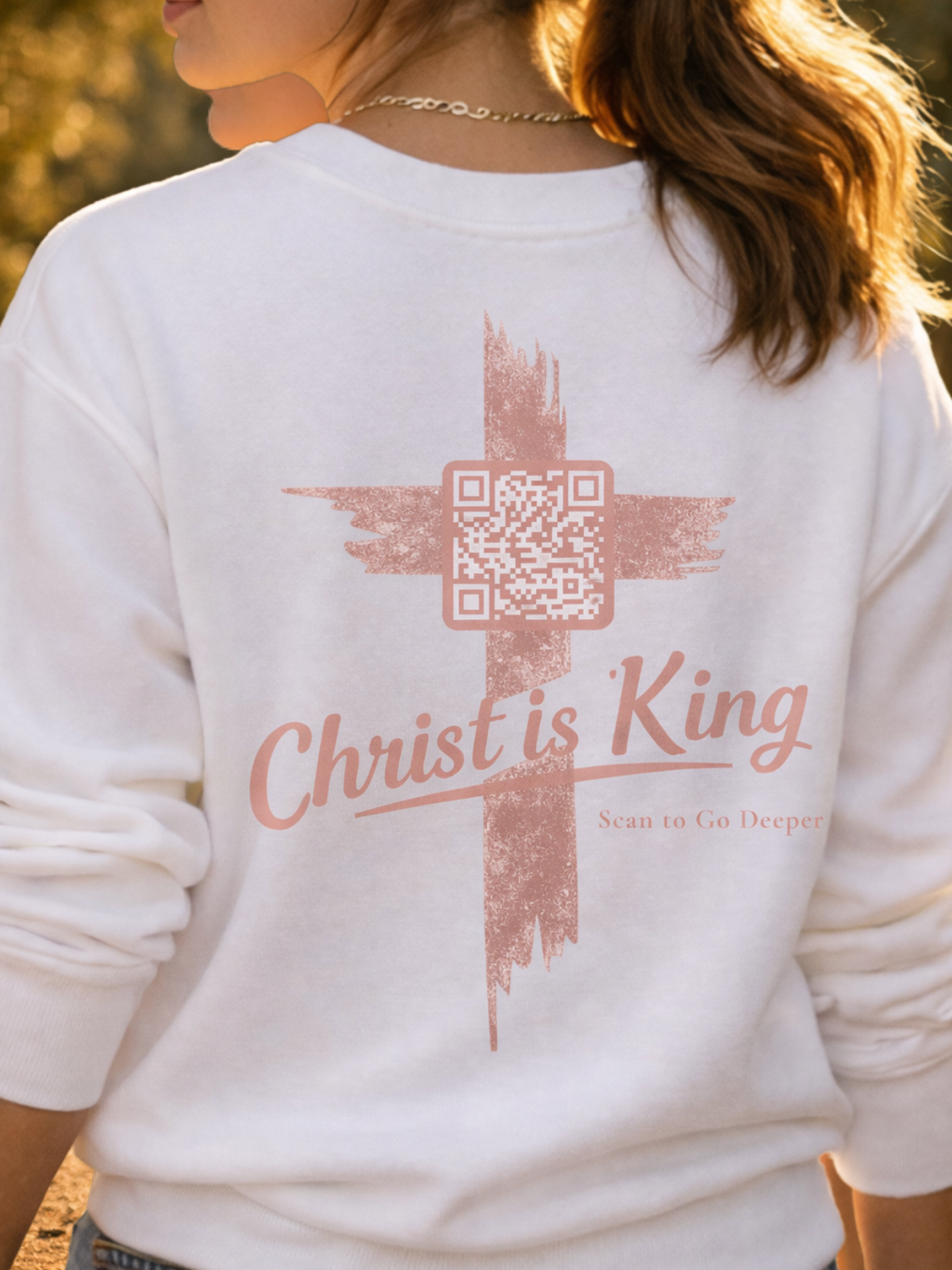 White sweatshirt with a cross design and 'Christ is King' text on the back. John 12:12-15